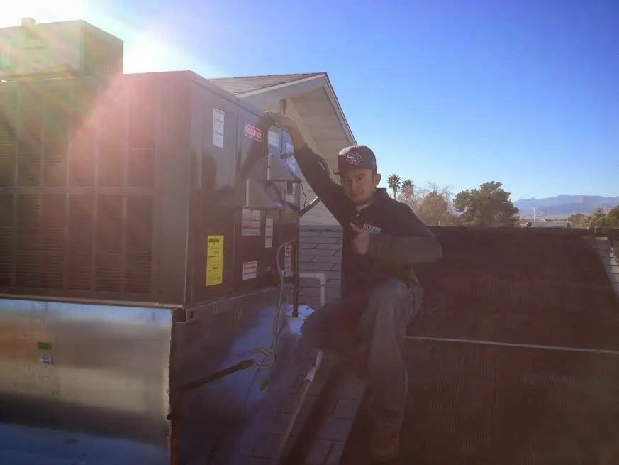 HVAC technician performing Boiler Repair on a rooftop unit in Pleasant Hill